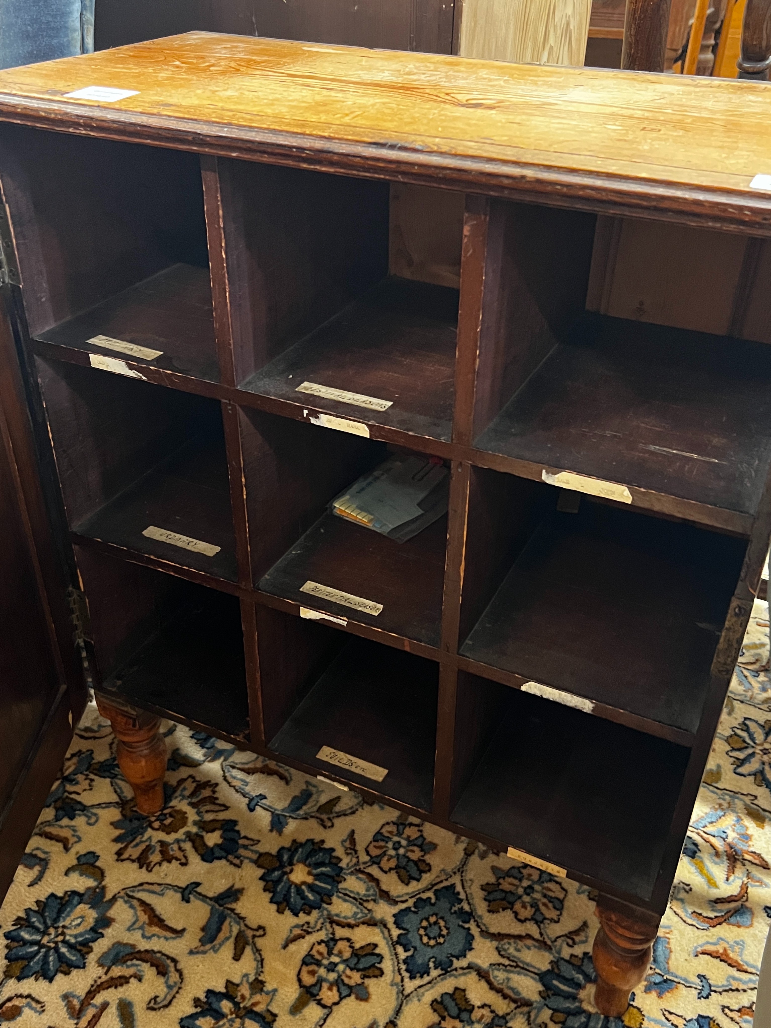 A 19th century French pine side cupboard with pigeonholed interior, width 63cm, depth 31cm, height 80cm